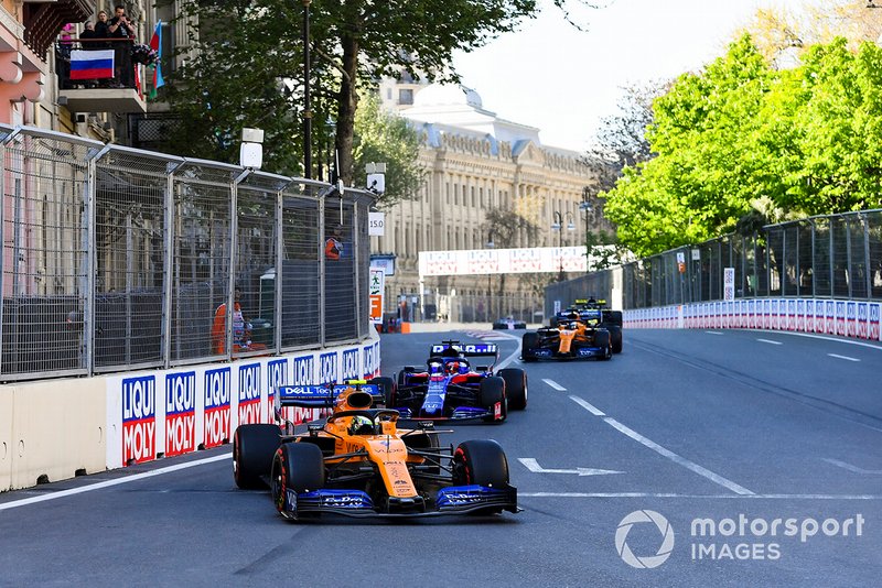 Lando Norris, McLaren MCL34, leads Daniil Kvyat, Toro Rosso STR14, and Carlos Sainz Jr., McLaren MCL34