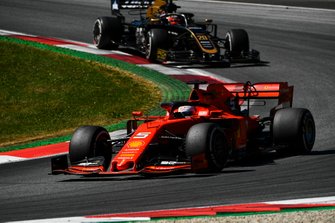 Sebastian Vettel, Ferrari SF90, leads Kevin Magnussen, Haas F1 Team VF-19