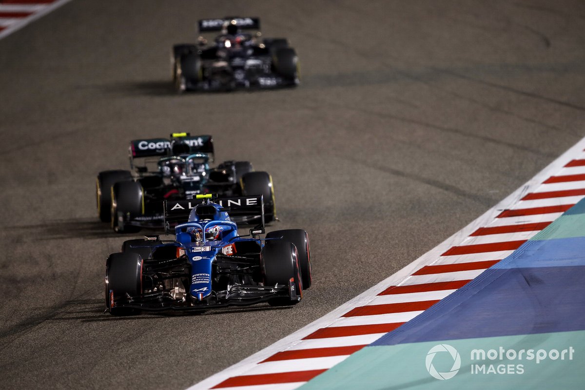 Esteban Ocon, Alpine A521, Sebastian Vettel, Aston Martin AMR21, and Lance Stroll, Aston Martin AMR21