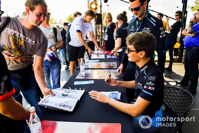 George Russell, Williams Racing signs autographs for fans
