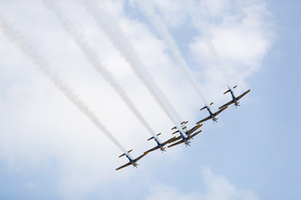 The Embraer EMB 314 Super Tucano's of the Brazilian Air Forces Smoke Squadron fly over the grid
