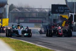 Lewis Hamilton, Mercedes AMG F1 W08, and Kevin Magnussen, Haas F1 Team VF-17, exit the pit lane
