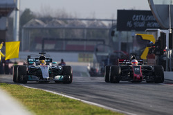 Lewis Hamilton, Mercedes AMG F1 W08, and Kevin Magnussen, Haas F1 Team VF-17, exit the pit lane