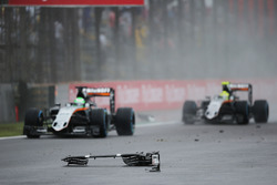 Nico Hulkenberg, Sahara Force India F1 VJM09 and Sergio Perez, Sahara Force India F1 VJM09 pass debris from the Sauber C35 of Marcus Ericsson, Sauber F1 Team