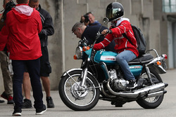 Sebastian Vettel, Ferrari arrives on a Suzuki 750 motor bike