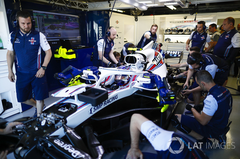 Engineers make adjustments to the car of Sergey Sirotkin, Williams FW41