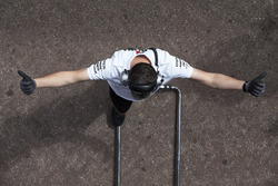 A Williams engineer signals to a driver in the teams garage