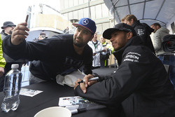 Lewis Hamilton, Mercedes AMG F1 poses for photographs with a young fan