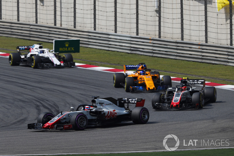 Romain Grosjean, Haas F1 Team VF-18 Ferrari, leads Kevin Magnussen, Haas F1 Team VF-18 Ferrari, and Fernando Alonso, McLaren MCL33 Renault