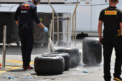 Red Bull Racing mechanic washes Pirelli tyres