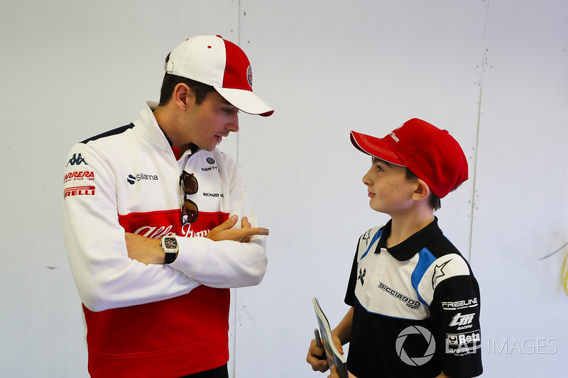 Charles Leclerc, Sauber, talks to a grid kid