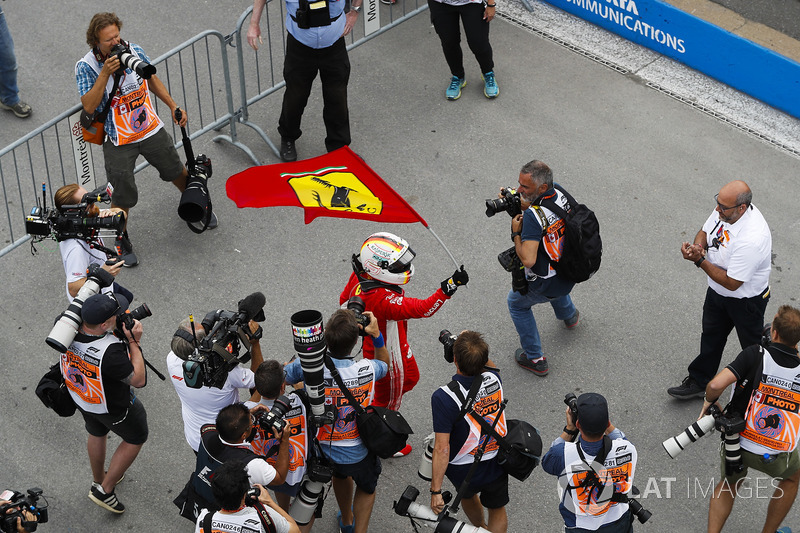 Sebastian Vettel, Ferrari, celebrates victory by waving a Prancing Horse flag