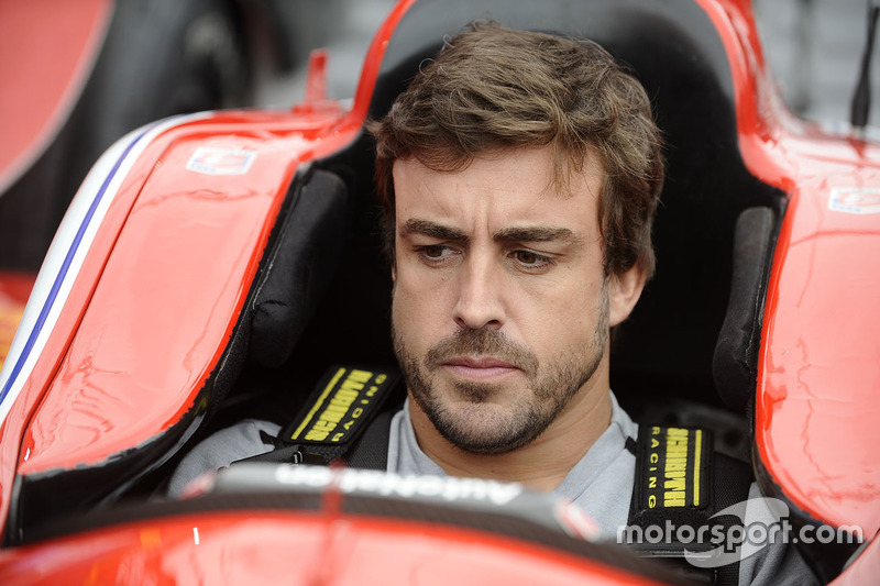 Fernando Alonso sits in the car of Marco Andretti