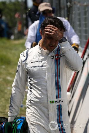 Race retiree Felipe Massa, Williams walks back after after crashing out of the race