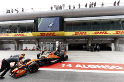 Fernando Alonso, McLaren MCL32, is wheeled back into his pit garage in the pit lane