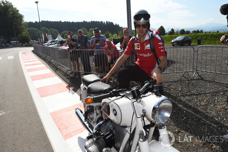 Sebastian Vettel, Ferrari arrives at the track on a vintage BMW motorbike