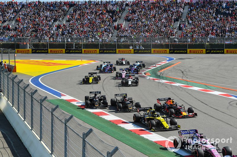 Sergio Perez, Racing Point RP19, leads Nico Hulkenberg, Renault F1 Team R.S. 19, Max Verstappen, Red Bull Racing RB15, Kevin Magnussen, Haas F1 Team VF-19, Romain Grosjean, Haas F1 Team VF-19, and the remainder of the field at the start