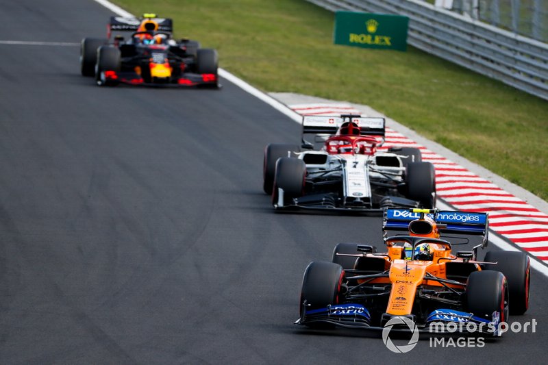 Lando Norris, McLaren MCL34, leads Kimi Raikkonen, Alfa Romeo Racing C38, and Pierre Gasly, Red Bull Racing RB15