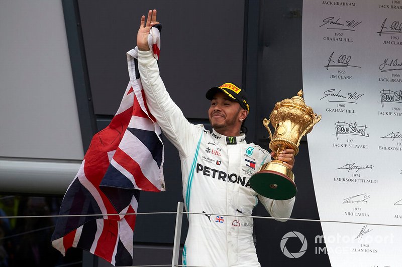 Lewis Hamilton, Mercedes AMG F1, 1st position, on the podium with his trophy