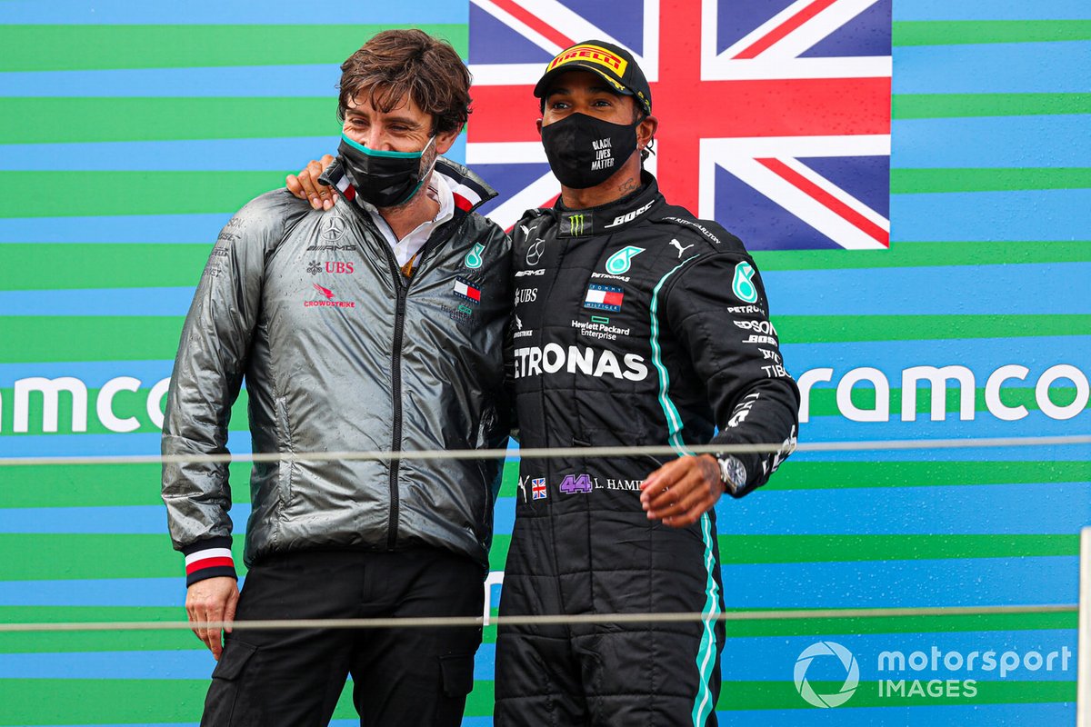 Lewis Hamilton, Mercedes-AMG F1, 1st position, and a Mercedes representative celebrate on the podium