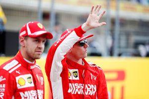 Sebastian Vettel, Ferrari, and Kimi Raikkonen, Ferrari, wave to the fans.