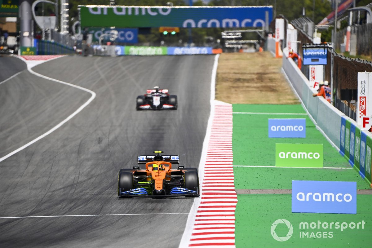 Lando Norris, McLaren MCL35, leads Romain Grosjean, Haas VF-20