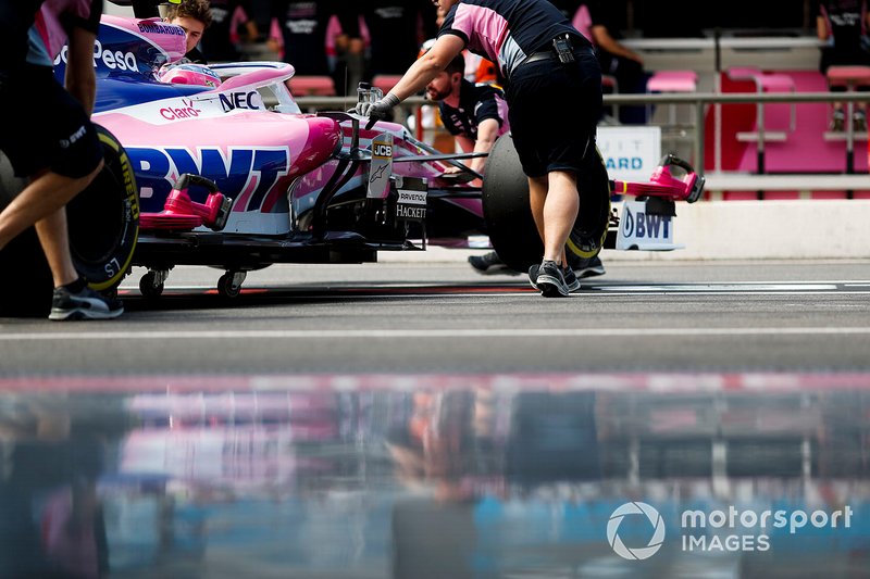 Mechanics move the car of Lance Stroll, Racing Point RP19
