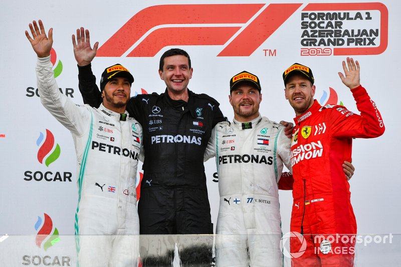 Lewis Hamilton, Mercedes AMG F1, the Mercedes Constructors trophy delegate, Valtteri Bottas, Mercedes AMG F1, 1st position, and Sebastian Vettel, Ferrari, 3rd position, on the podium