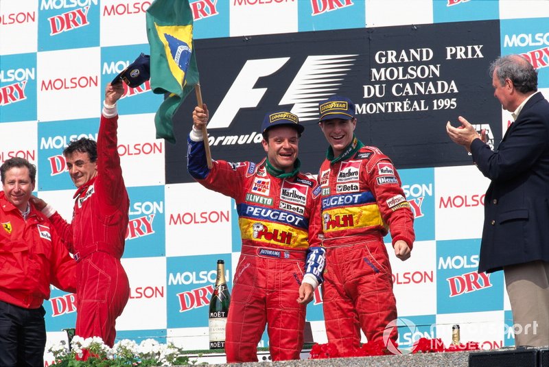 Rubens Barrichello, Jordan, 2nd position, and Jordan teammate Eddie Irvine, Jordan, 3rd position, celebrate on the podium