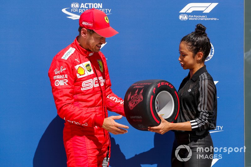 Sebastian Vettel, Ferrari, is presented with his Pirelli Pole Position Award by actress Liza Koshy