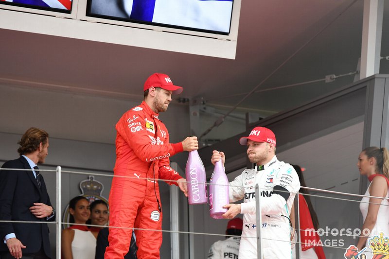 Sebastian Vettel, Ferrari, 2nd position, and Valtteri Bottas, Mercedes AMG F1, 3rd position, celebrate on the podium