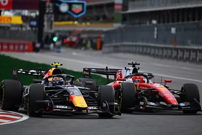 Charles Leclerc, Ferrari; Isack Hadjar, Red Bull Racing