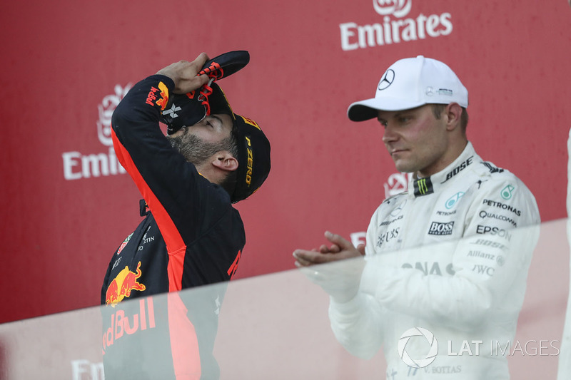 Race winner Daniel Ricciardo, Red Bull Racing celebrates, Valtteri Bottas, Mercedes AMG F1 on the podium and does a shoey, the champagne