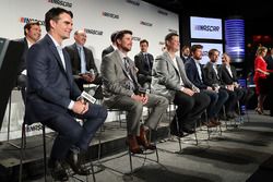 NASCAR drivers and executives sit on stage during a press conference outlining the changes to the 20