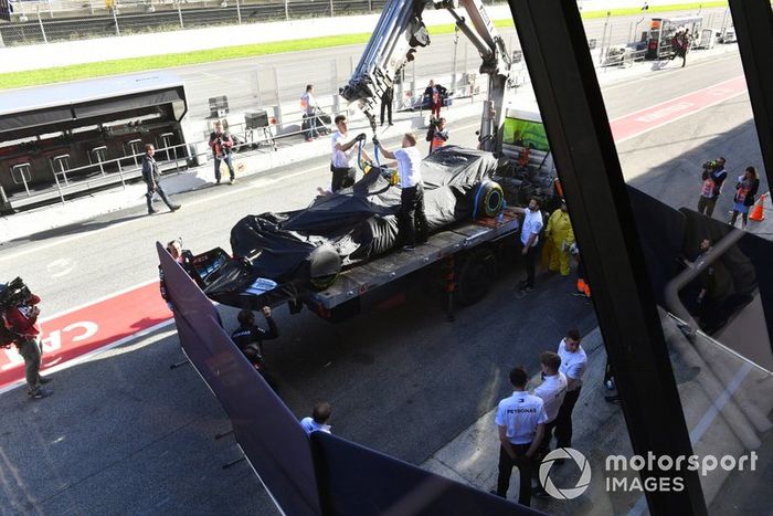 Lewis Hamilton's Mercedes F1 W11 is returned to the pits