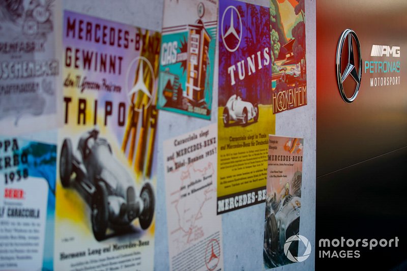 A wall of posters celebrating 125 years in motor racing for Mercedes