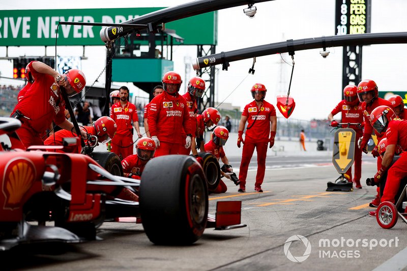 The Ferrari team stop one of their cars during practice.
