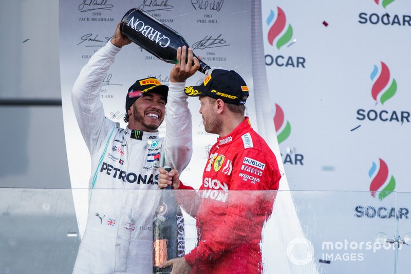 Lewis Hamilton, Mercedes AMG F1, 2nd position, pours Champagne over Sebastian Vettel, Ferrari, 3rd position