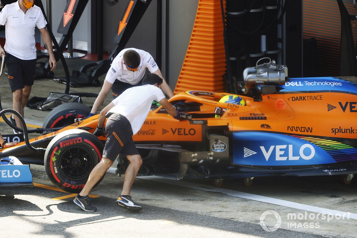 Lando Norris, McLaren MCL35, is returned to the garage