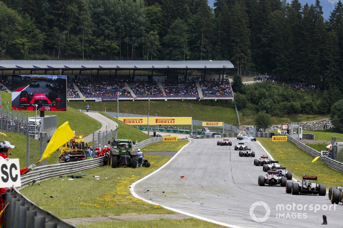 The Safety Car leads the field as Marshals clear the scene of the crash between Kimi Raikkonen, Ferrari SF-15T, and Fernando Alonso, McLaren MP4-30 Honda
