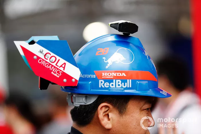 A fan with a Toro Rosso themed hat