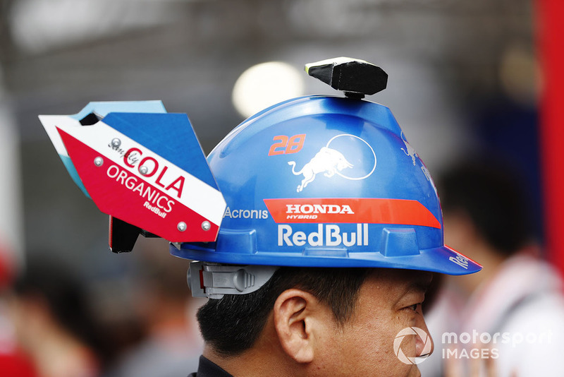 A fan with a Toro Rosso themed hat