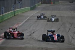 (L to R): Kimi Raikkonen, Ferrari SF16-H and Pascal Wehrlein, Manor Racing MRT05 battle for position