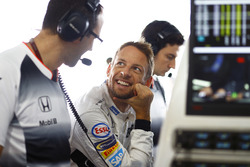 Jenson Button, McLaren talks to engineers in the garage