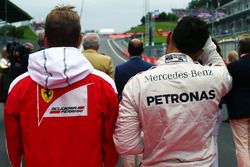 (L to R): Kimi Raikkonen, Ferrari and Lewis Hamilton, Mercedes AMG F1 as the grid observes the natio