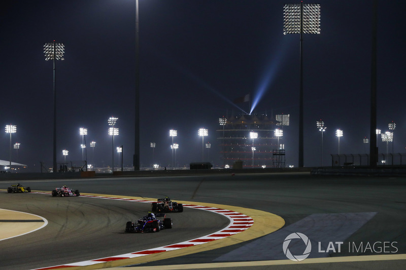 Pierre Gasly, Toro Rosso STR13 Honda, leads Kevin Magnussen, Haas F1 Team VF-18 Ferrari, and Esteban