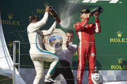 Second place Sebastian Vettel, Ferrari, the Mercedes Constructors trophy delegate and race winner Lewis Hamilton, Mercedes AMG F1, on the podium