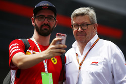 Ross Brawn, Managing Director of Motorsports, FOM, poses for a selfie with a fan