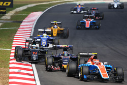 Esteban Ocon, Manor Racing MRT05 leads Carlos Sainz Jr., Scuderia Toro Rosso STR11 and Fernando Alonso, McLaren MP4-31