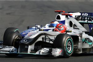 Michael Schumacher, Mercedes GP MGP W01 and Rubens Barrichello, Williams FW32 battle for position